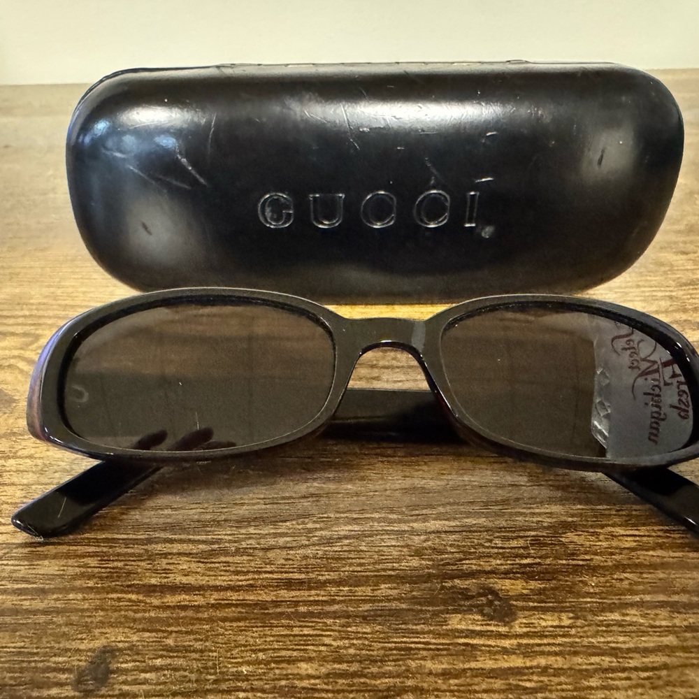 Gucci Black Oval Sunglasses with Dark Lenses